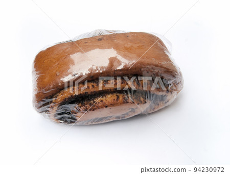 Buns with poppy seeds in plastic packaging on white background 94230972