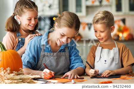 Young family mother and children preparing decorations for Halloween Young family mother and children preparing decorations for Halloween 94232460