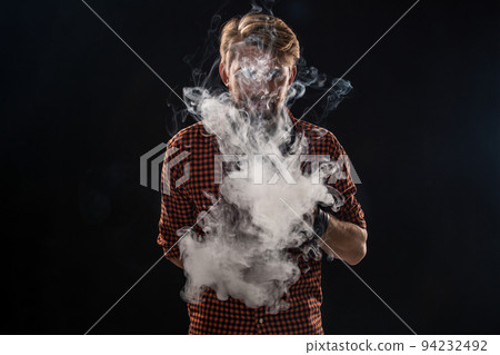A young man with a beard and a stylish hairstyle in a shirt, smoking a cigarette, a viper, a room, a studio, smoke, enjoyment 94232492