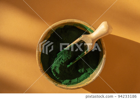Blue-green algae Chlorella and spirulina powder in bamboo eco bowl. Super powder in spoon. Detox superfood. Natural supplement of algae Blue-green algae Chlorella and spirulina powder in bamboo eco bowl. Super powder in spoon. Detox superfood. Natural supplement of algae 94233186