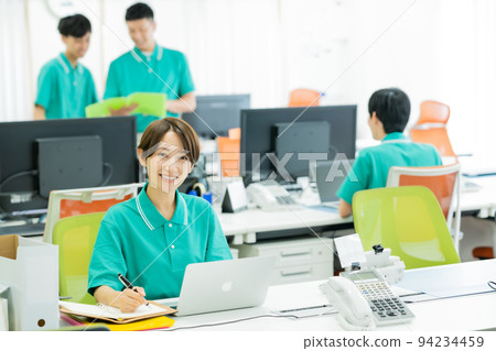 Young woman in uniform working in the office 94234459