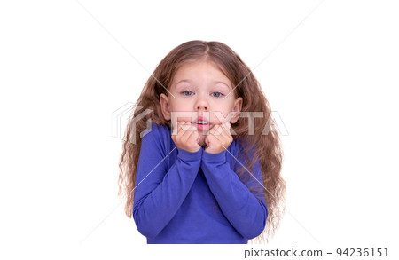 Freezing little girl feeling cold holding raised fists close to face because of coldness 94236151