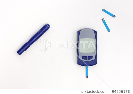 Top view of glucometer, lancet and test strips 94236178
