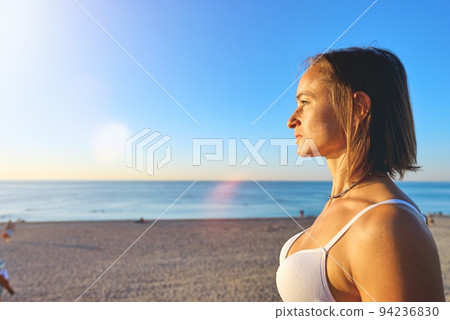 A young woman is practicing yoga on the ocean. A young woman is practicing yoga on the ocean. 94236830