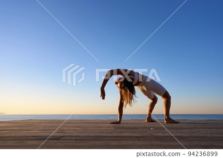 Young sporty woman training in outdoor, working out at animal flow style, making crab position 94236899