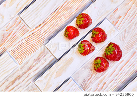 Fresh juicy strawberries full of vitamins on a wooden surface 94236900