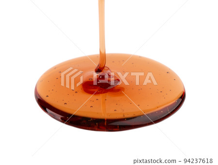 Caramel syrup drizzle isolated on white background. Splashes of sweet caramel sauce. Caramel syrup drizzle isolated on white background. Splashes of sweet caramel sauce. 94237618