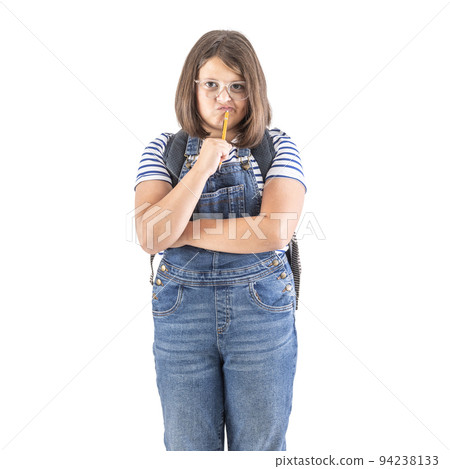 Schoolgirl in glasses holds arms crossed and pencil close to her mouth thinking hard 94238133