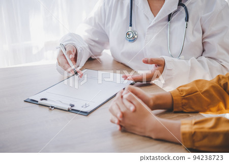 Close-up of the psychiatrist's hand holding the patient's hand. To encourage and comfort the patient. Close-up of the psychiatrist's hand holding the patient's hand. To encourage and comfort the patient. 94238723