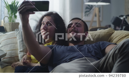 Woman with a disability and man taking selfie Woman with a disability and man taking selfie 94239780