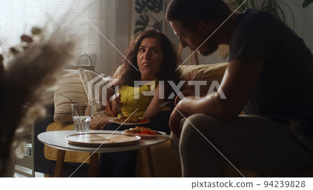 Wife with disability and husband eating Wife with disability and husband eating 94239828