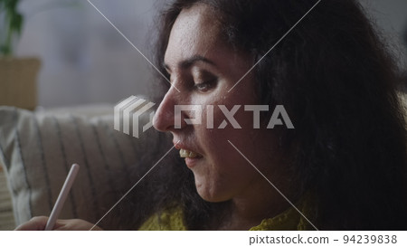 Woman using illustration app on tablet 94239838
