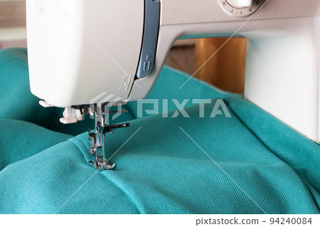 Modern sewing machine and turquoise fabric Modern sewing machine and turquoise fabric 94240084