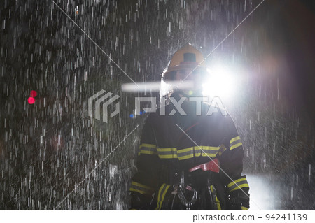 Portrait of a female firefighter standing and walking brave and optimistic. Portrait of a female firefighter standing and walking brave and optimistic. 94241139