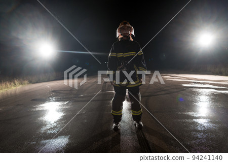 Portrait of a female firefighter standing and walking brave and optimistic. Portrait of a female firefighter standing and walking brave and optimistic. 94241140