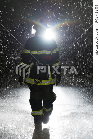 Portrait of a female firefighter standing and walking brave and optimistic. Portrait of a female firefighter standing and walking brave and optimistic. 94241204