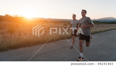 group of young sporty people jogging on a sunny morning in the city. 94241403