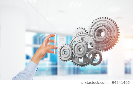 Engine mechanism in male hands as symbol for cooperation or teamworking. Mixed media Engine mechanism in male hands as symbol for cooperation or teamworking. Mixed media 94241405