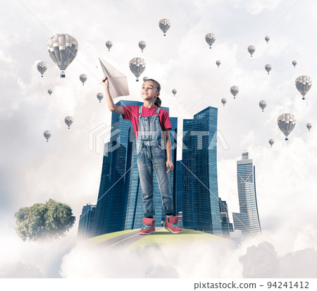 Concept of careless happy childhood with girl dreaming about future 94241412