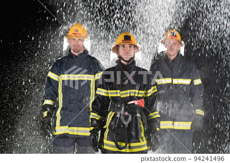 Portrait of a group of firefighters standing and walking brave and optimistic with a female as team leader. Portrait of a group of firefighters standing and walking brave and optimistic with a female as team leader. 94241496