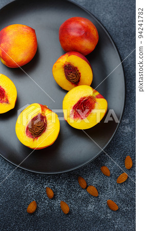 fresh sweet peaches on dark table 94241782