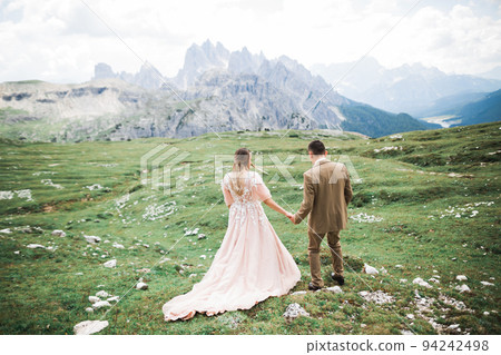 Loving husband and woman on the background of the mountains. Loving couple emotionally spends time 94242498