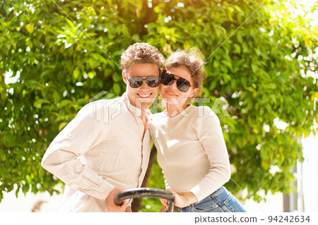 Happy cheerful couple in sunglasses Happy cheerful couple in sunglasses 94242634