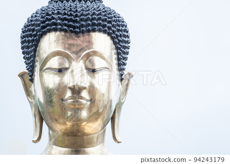 The close up of Buddha statue face on isolated white sky. 94243179