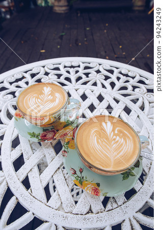 A set of vintage twin hot coffee latte on the table. 94243249