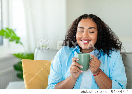 Happy Black Woman Having Morning Coffee Enjoying Taste At Home Happy Black Woman Having Morning Coffee Enjoying Taste At Home 94244725