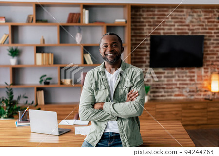 Glad happy confident handsome middle aged african american man in casual with crossed arms look at camera 94244763