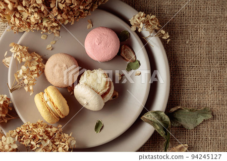 Delicious sweet colorful macaroons with dried flowers. 94245127