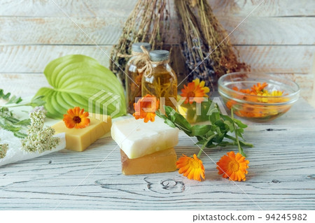 Calendula flowers, soap, oils and tinctures, on a wooden background, natural ingredients, alternative medicine Calendula flowers, soap, oils and tinctures, on a wooden background, natural ingredients, alternative medicine 94245982