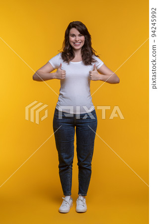 Woman smiling at camera gesturing ok sign 94245992