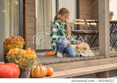 Teenage girl spending time with her canine outdoors 94246022