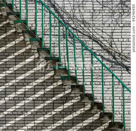 Iron stairs along a brick wall 94246480
