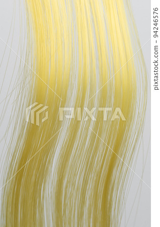 Yellow curly hair strands Yellow curly hair strands 94246576