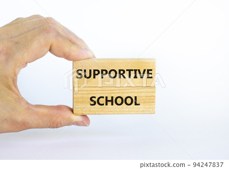 Supportive school symbol. Wooden blocks with words 'Supportive school' on beautiful white background. Businessman hand. Business and supportive school concept. Copy space. 94247837