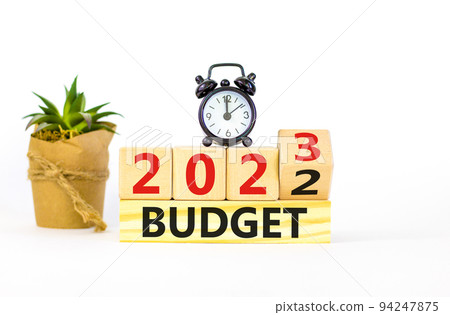 Planning 2023 budget new year symbol. Turned wooden cube and changes words Budget 2022 to Budget 2023. Black alarm clock. Beautiful white background, copy space. Business 2023 budget new year concept. Planning 2023 budget new year symbol. Turned wooden cube and changes words Budget 2022 to Budget 2023. Black alarm clock. Beautiful white background, copy space. Business 2023 budget new year concept. 94247875