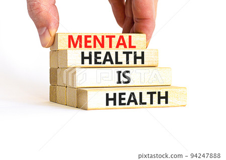 Mental health psychological symbol. Concept words Mental health is health on wooden blocks on a beautiful white table white background. Psychologist hand. Psychological mental health concept. Mental health psychological symbol. Concept words Mental health is health on wooden blocks on a beautiful white table white background. Psychologist hand. Psychological mental health concept. 94247888