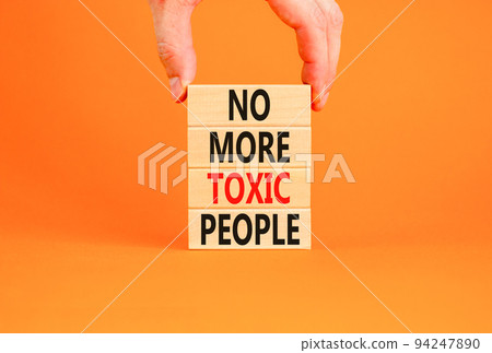 No more toxic people symbol. Concept words No more toxic people on wooden blocks on a beautiful orange table orange background. Psychologist hand. Business, psychological no more toxic people concept. No more toxic people symbol. Concept words No more toxic people on wooden blocks on a beautiful orange table orange background. Psychologist hand. Business, psychological no more toxic people concept. 94247890