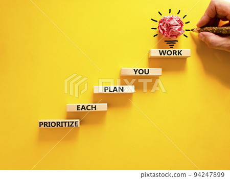 Prioritize each plan you work symbol. Concept words Prioritize each plan you work on blocks on beautiful yellow background. Businessman hand. Business prioritize each plan you work concept. Copy space Prioritize each plan you work symbol. Concept words Prioritize each plan you work on blocks on beautiful yellow background. Businessman hand. Business prioritize each plan you work concept. Copy space 94247899