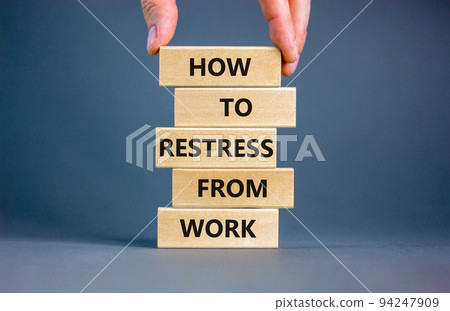 Restress from work symbol. Concept words How to restress from work on wooden blocks. Doctor hand. Beautiful grey background. Psychological business and restress from work concept. Copy space. 94247909