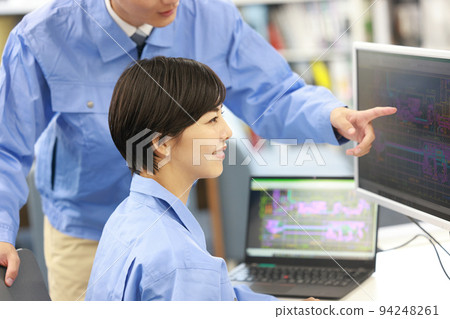 Female designer receiving an explanation of CAD work from seniors_1 94248261