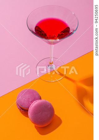 Pink summer cocktail with sweet cookies on color abckground Pink summer cocktail with sweet cookies on color abckground 94250695