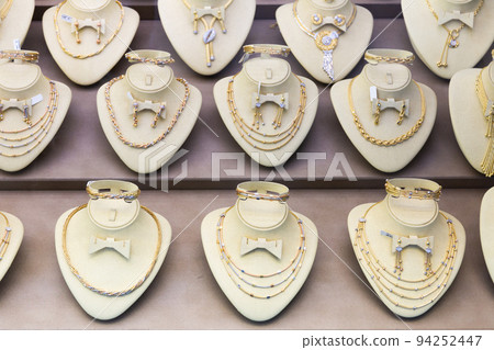 Variety of gold jewelry displayed for sale 94252447