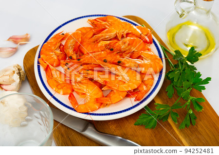 Dish of Spanish cuisine - baked in oven langoustine served with lemon 94252481