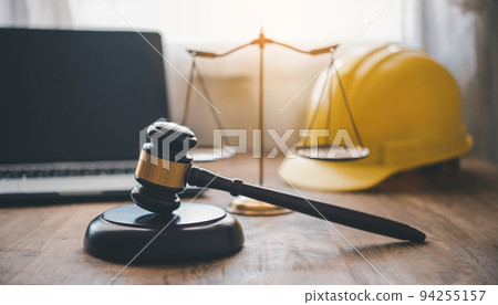 Judge's hammer and helmet Law and Justice about labor law concept Construction law. Judge's hammer and helmet Law and Justice about labor law concept Construction law. 94255157