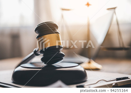 Law theme, mallet of the judge, law enforcement officers, evidence-based cases and documents taken into account 94255164