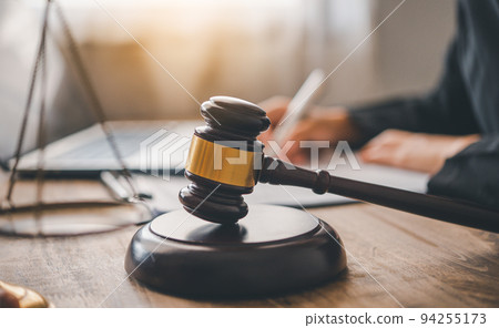 Law theme, mallet of the judge, law enforcement officers, evidence-based cases, and documents taken into account.. 94255173